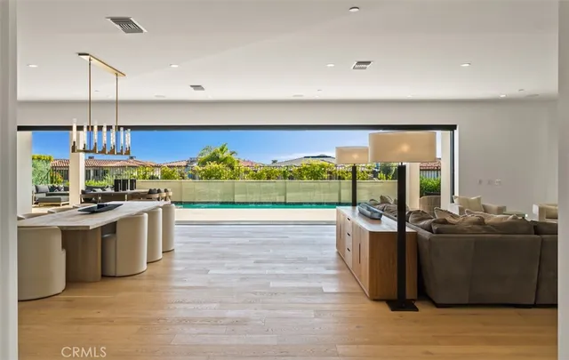 a open kitchen with stainless steel appliances granite countertop a lot of cabinets and wooden floor