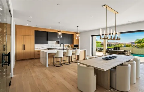 a kitchen with kitchen island a white counter top space a sink appliances and cabinets