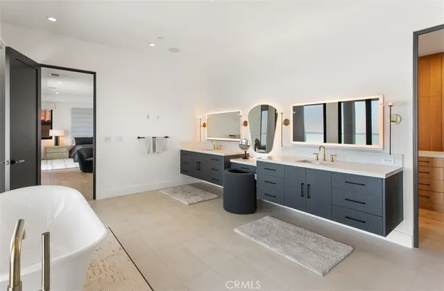 a spacious bathroom with a granite countertop sink and a mirror