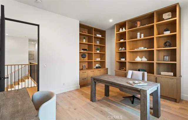 a view of a workspace with furniture and a bookshelf