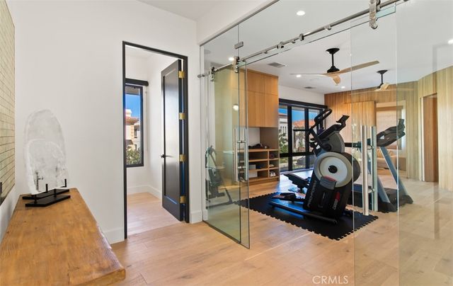 a room with gym equipment and a flat screen tv