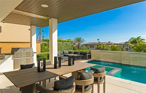 a view of swimming pool with outdoor seating and plants
