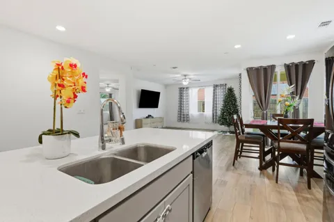 a kitchen with a sink cabinets and wooden floor