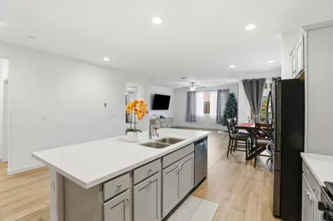 a kitchen with a sink cabinets and wooden floor