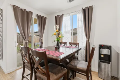 a dining room with furniture and window