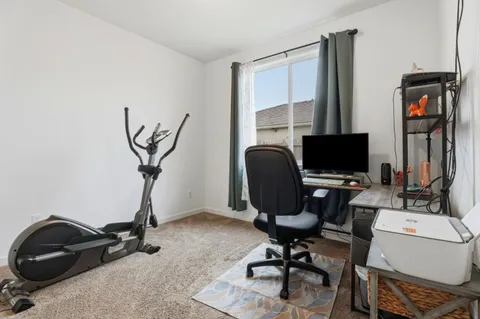 a view of a workspace with furniture and a gate