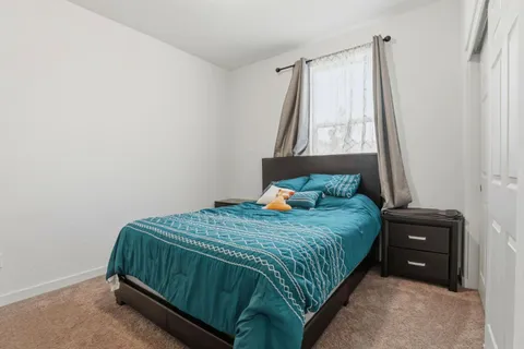 a bedroom with a bed and window