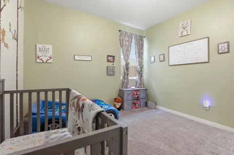 a view of a bedroom with baby bed