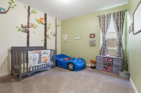 a children room with toys and a book shelf
