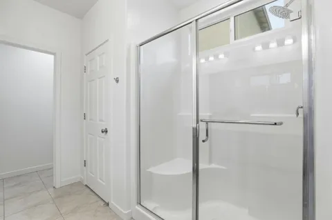 a bathroom with a glass shower door