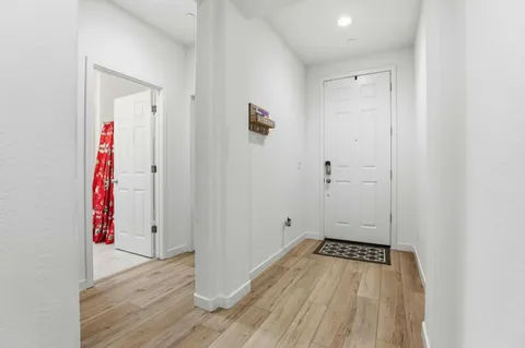 an empty room with wooden floor and closet