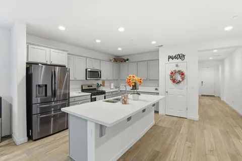 a kitchen with a sink appliances and cabinets
