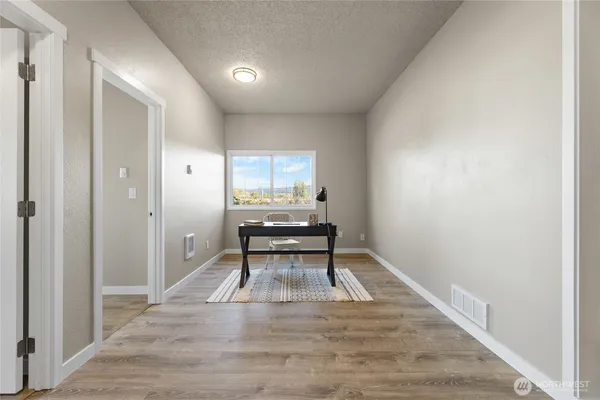 a view of an empty room and wooden floor