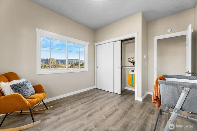 a view of room with furniture and wooden floor