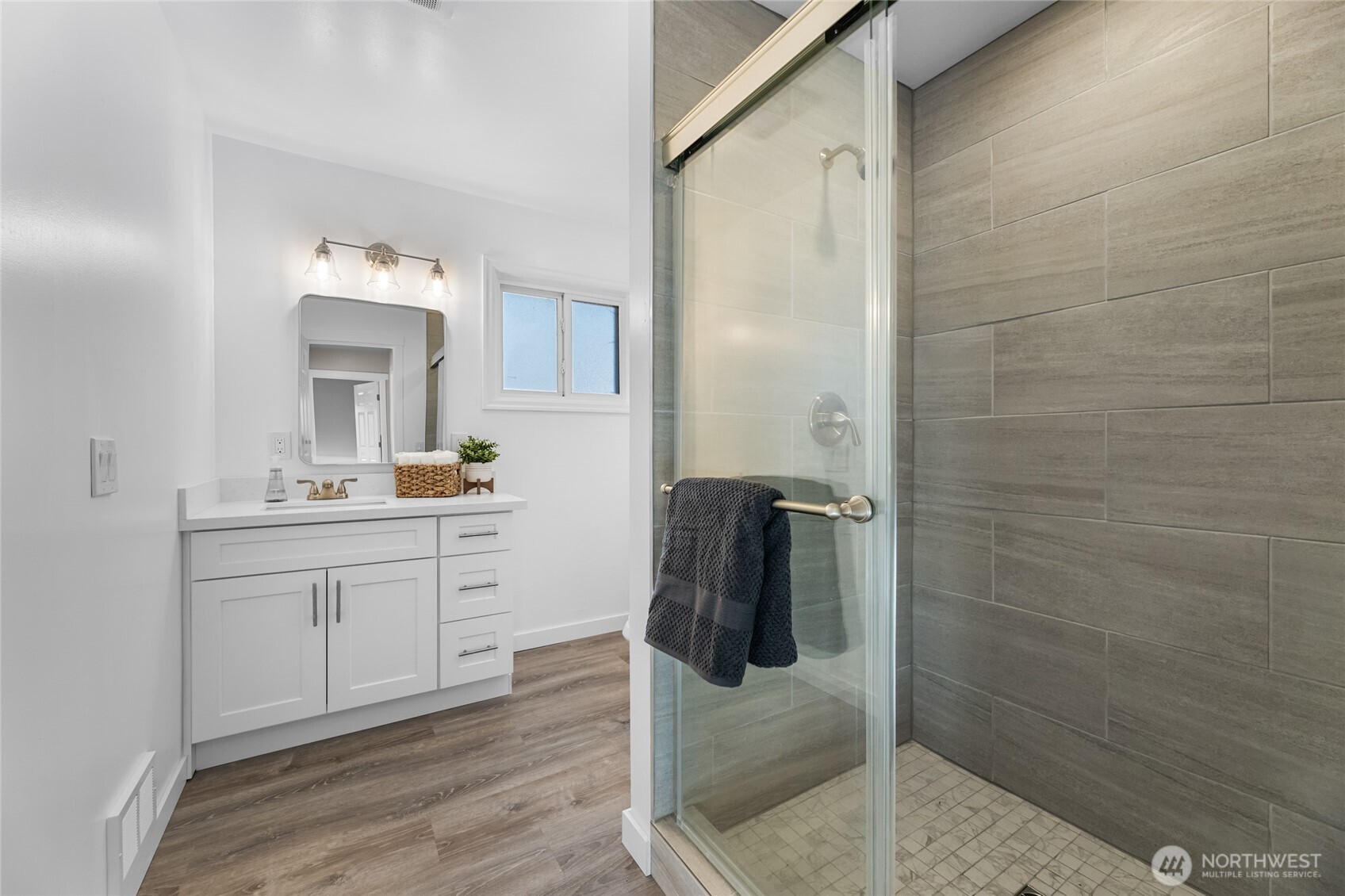 18008 202nd Street East Orting, WA 98360 - Photo 18 of 35 a bathroom with a sink a mirror and shower