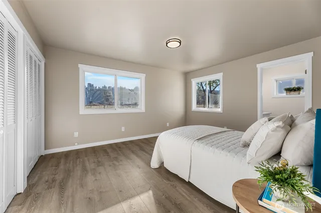 a bedroom with a bed and a painting on the wall