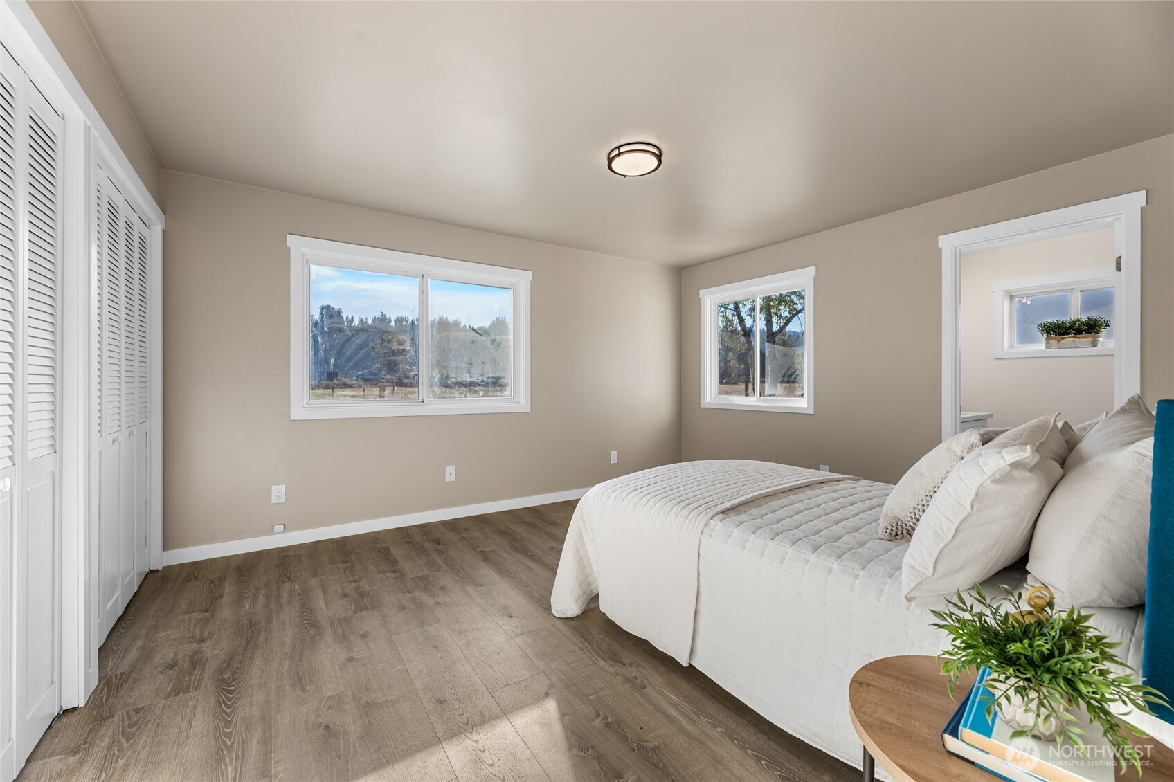 18008 202nd Street East Orting, WA 98360 - Photo 20 of 35 a bedroom with a bed and a painting on the wall