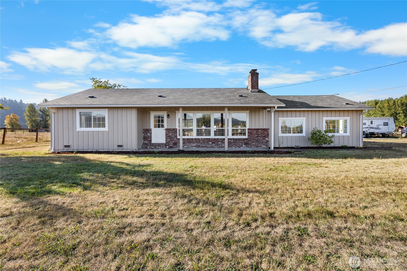 18008 202nd Street East Orting, WA 98360 - Photo 2 of 35 a front view of a house with a yard table and chairs