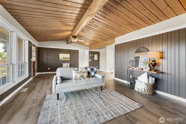 a living room with furniture and a wooden floor