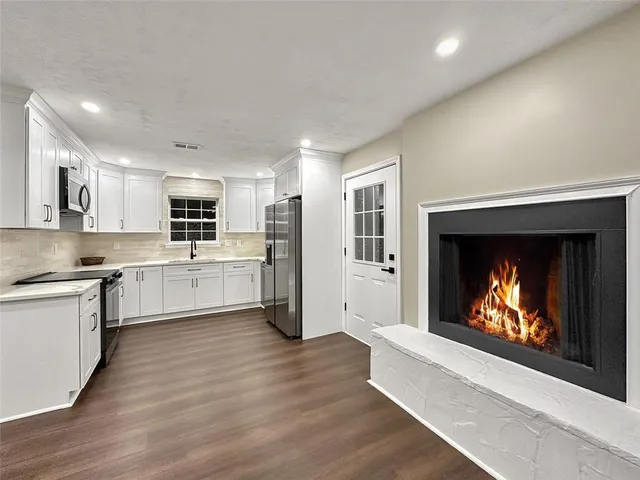 a large kitchen with a stove top oven and refrigerator