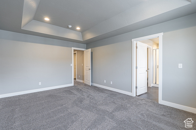2242 South 1120 West, Unit 69 Logan, UT 84321 - Photo 21 of 26 Empty room featuring dark colored carpet, a tray ceiling, and recessed lighting