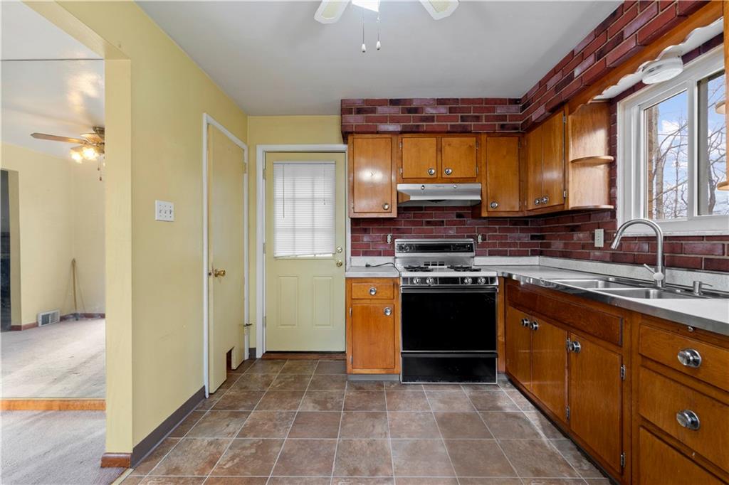461 Eicher Road Pittsburgh, PA 15237 - Photo 11 of 28 a kitchen with stainless steel appliances granite countertop a stove a sink and a refrigerator