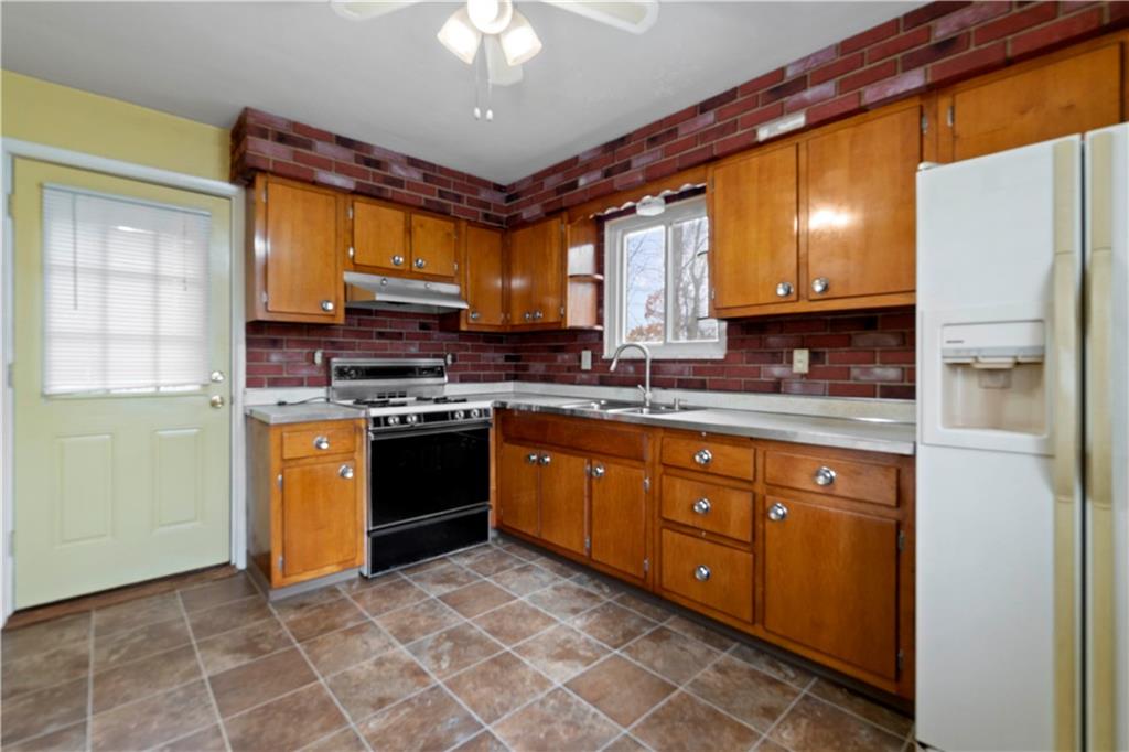 461 Eicher Road Pittsburgh, PA 15237 - Photo 10 of 28 a kitchen with stainless steel appliances granite countertop a stove a sink and a refrigerator