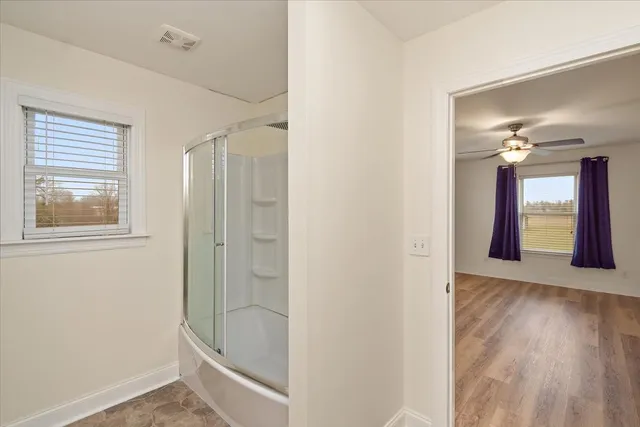 a bathroom with a bathtub and a shower