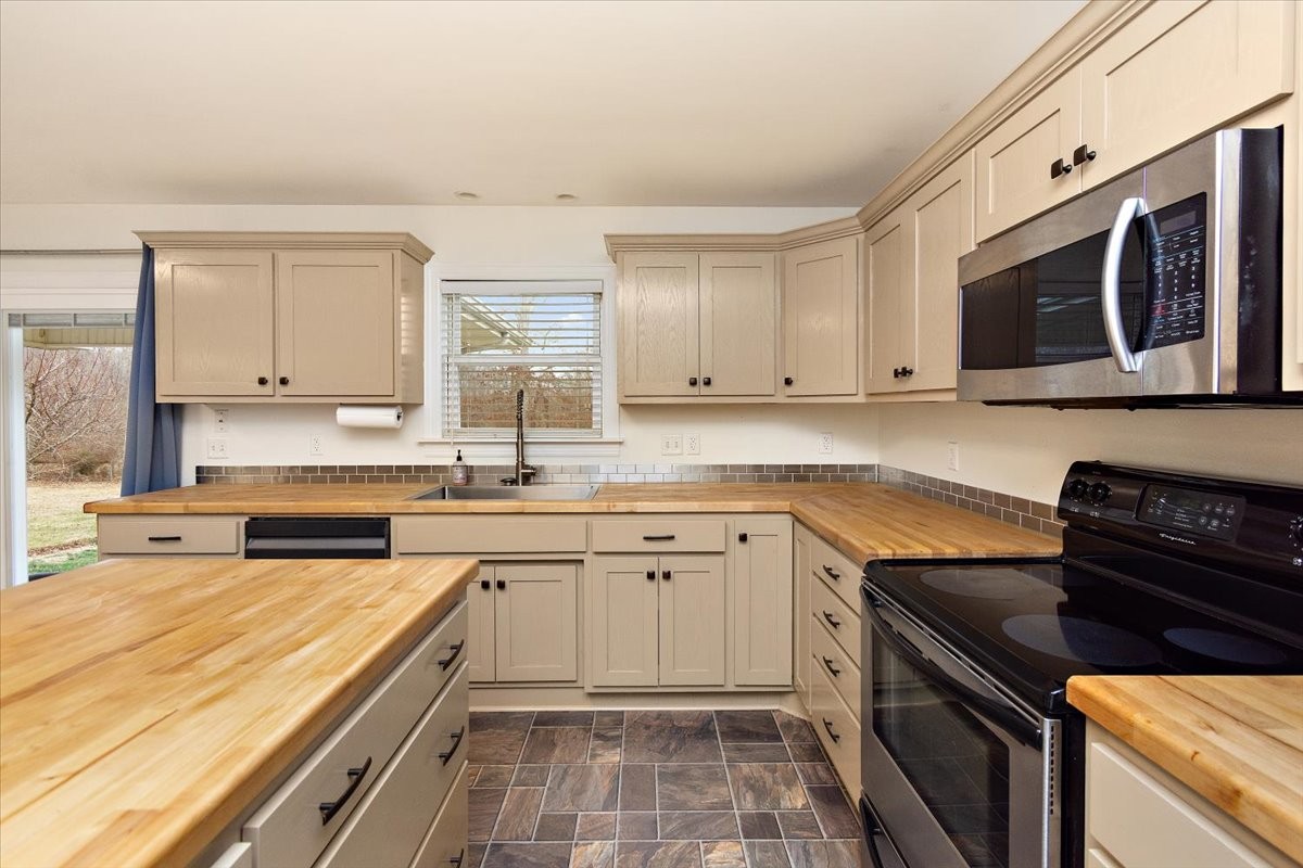 183 Gilliam Lane Tullahoma, TN 37388 - Photo 8 of 28 a kitchen with stainless steel appliances granite countertop a stove a sink and a microwave