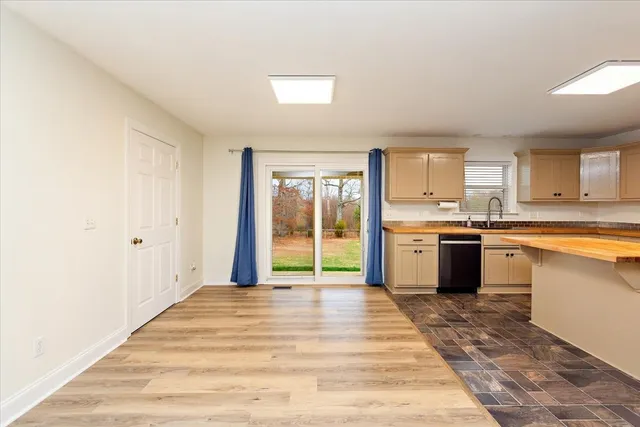 a large white kitchen with sink and cabinets