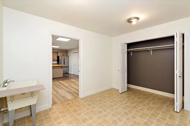 a view of a room that has a bed and a view of bathroom