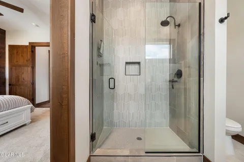 a bathroom with a shower toilet and sink