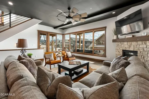 a living room with furniture a flat screen tv and a fireplace