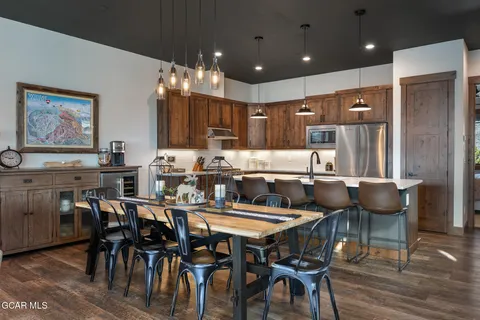 a dining table with chairs and wooden floor