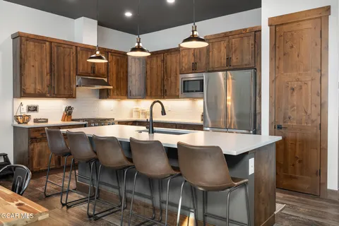 a kitchen with a sink cabinets and stainless steel appliances