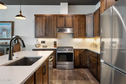 a kitchen with a table chairs sink and cabinets