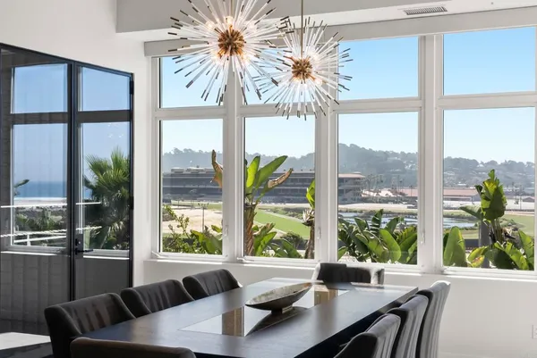 a living room with furniture and a large window with outer view