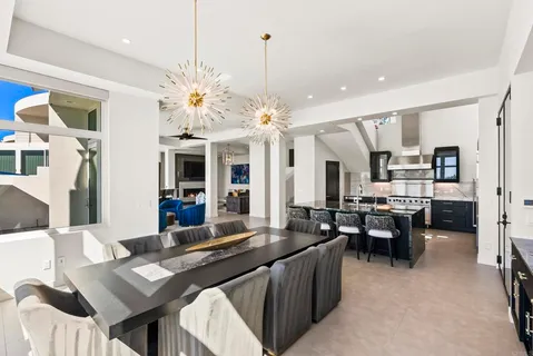 a large kitchen with a table and chairs
