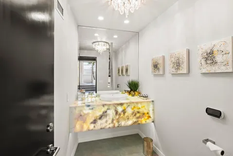 a bathroom with a tub sink and mirror