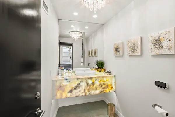 a bathroom with a tub sink and mirror