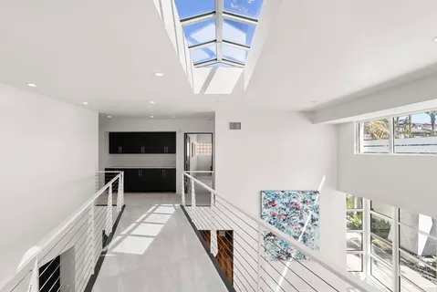 a view of a hallway with furniture and window