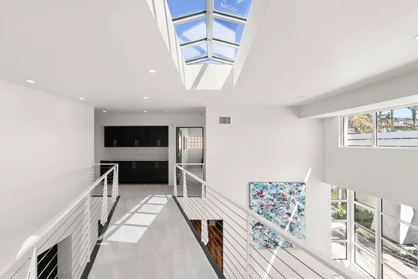 a view of a hallway with furniture and window