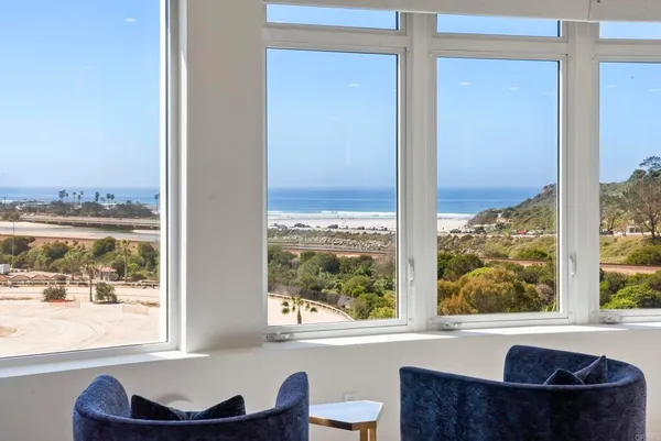 a living room with a large window and a table