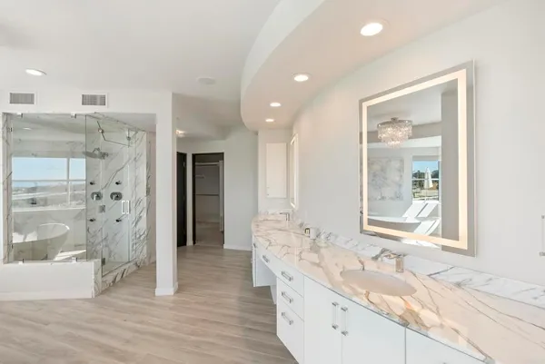 a bathroom with a granite countertop sink mirror and shower