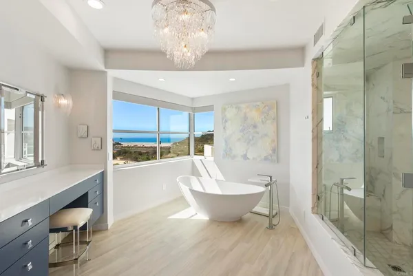 a spacious bathroom with a large tub shower and sink