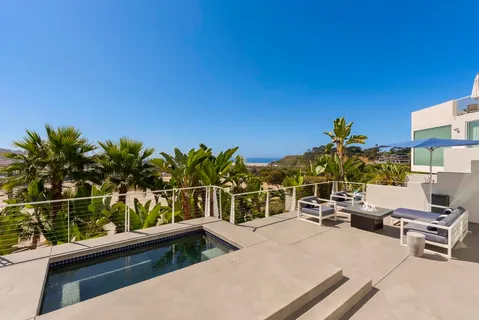 a view of a chairs and table in the balcony