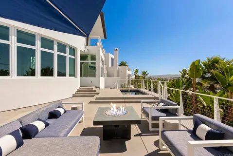 a view of a balcony with table and chairs