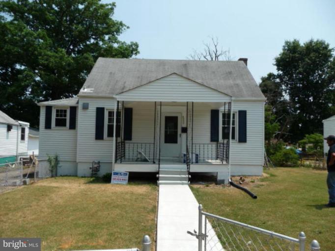 4502 Morgan Road Suitland, MD 20746 - Photo 1 of 14 a view of a white house with large windows and a table and chairs