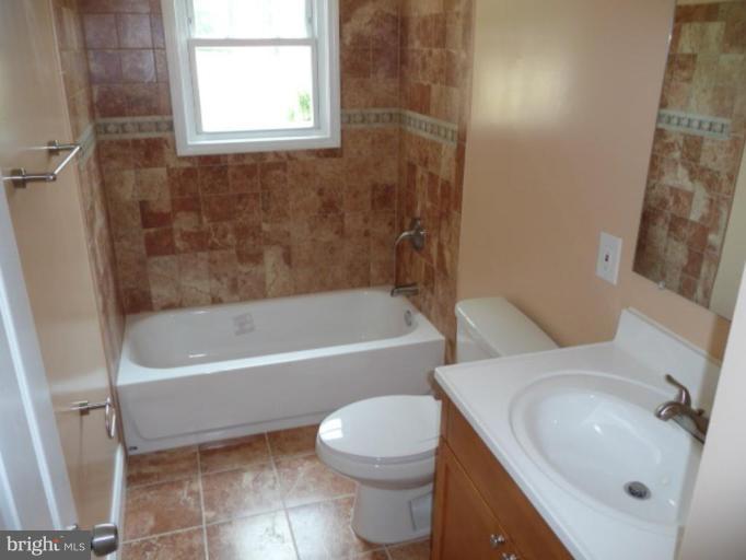 4502 Morgan Road Suitland, MD 20746 - Photo 3 of 14 a bathroom with a sink toilet and bathtub