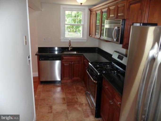 4502 Morgan Road Suitland, MD 20746 - Photo 8 of 14 a kitchen with a refrigerator and a sink